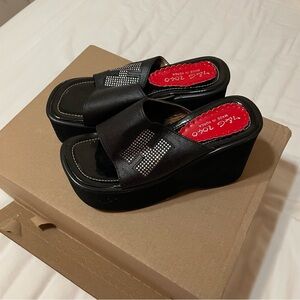 Black platform sandals with rhinestone H detailing